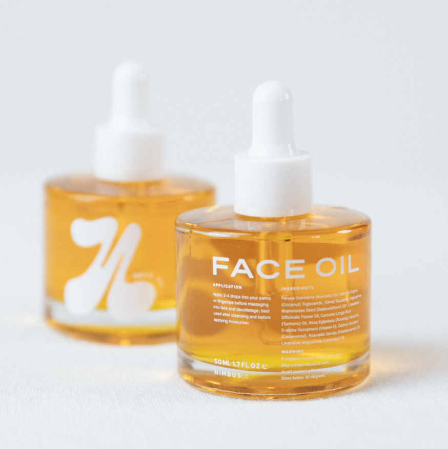 Two bottles of face oil with droppers on a white background