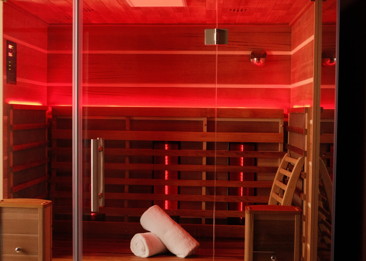 Infrared sauna with red lighting and wooden interior