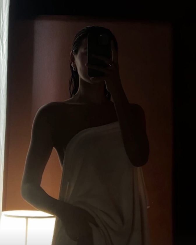 Person in a white robe holding a glass of water with text 'Fueling your vitality' above.